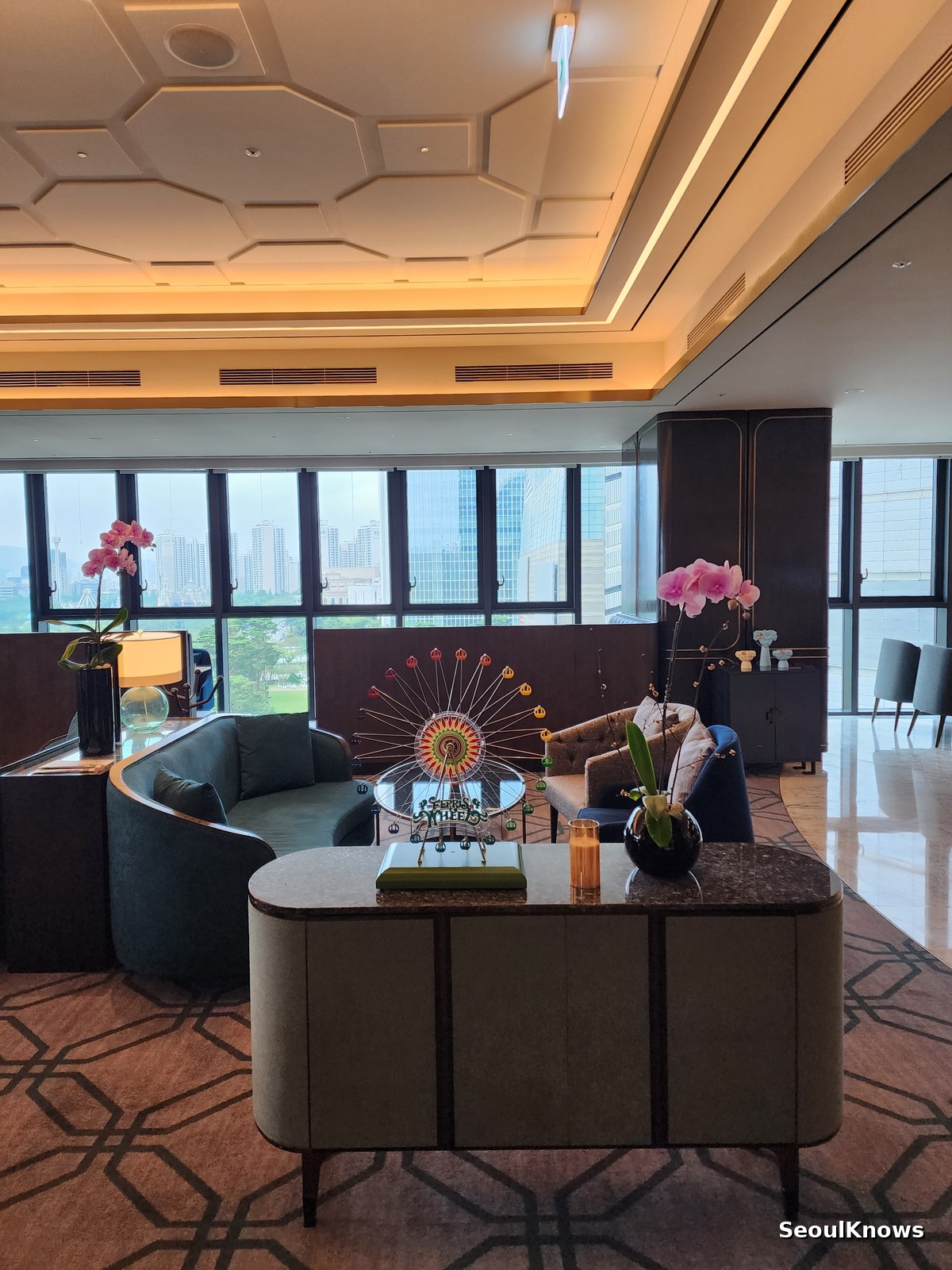 Console table with orchids beside the window at L'Espace Sofitel Ambassador Seoul