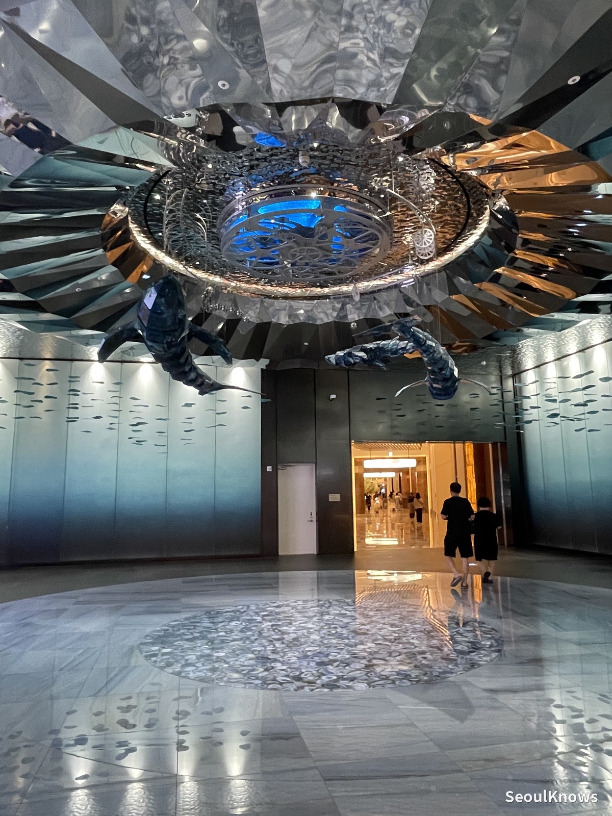 Silver whale sculpture suspended in the Inspire Resort lobby