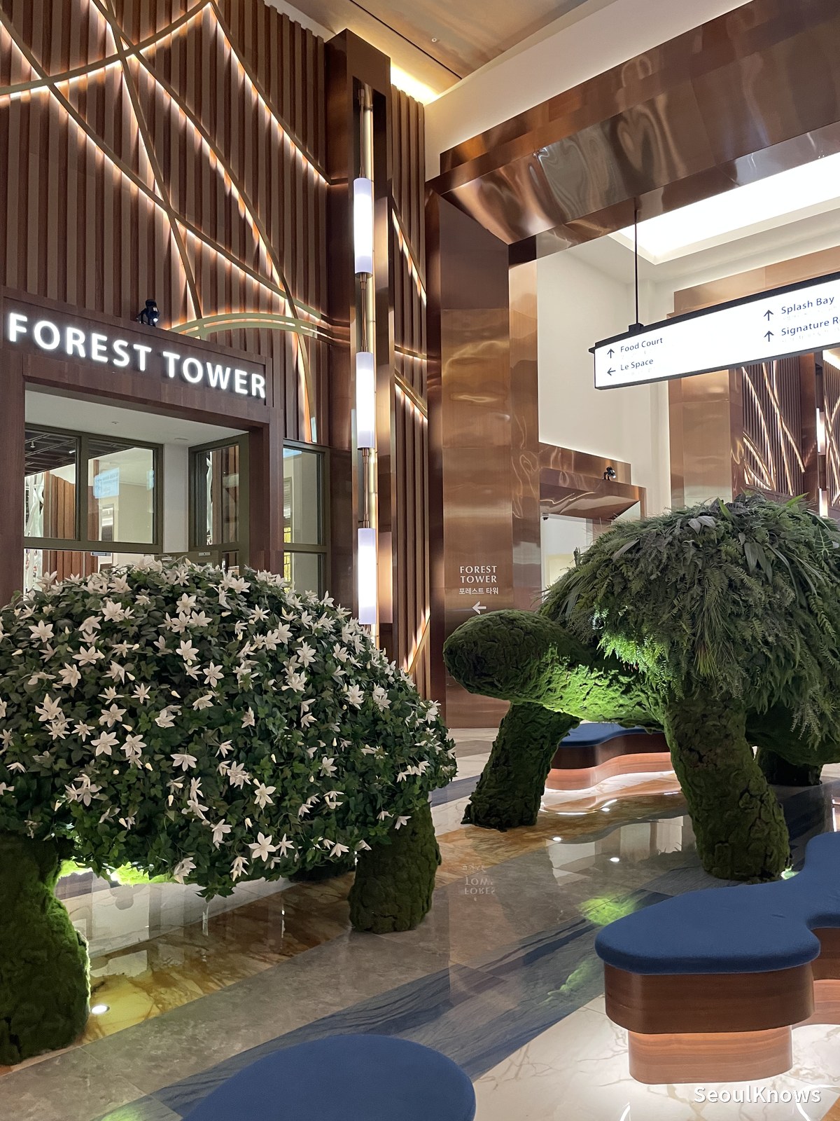 Green bear topiary at the Forest Tower entrance