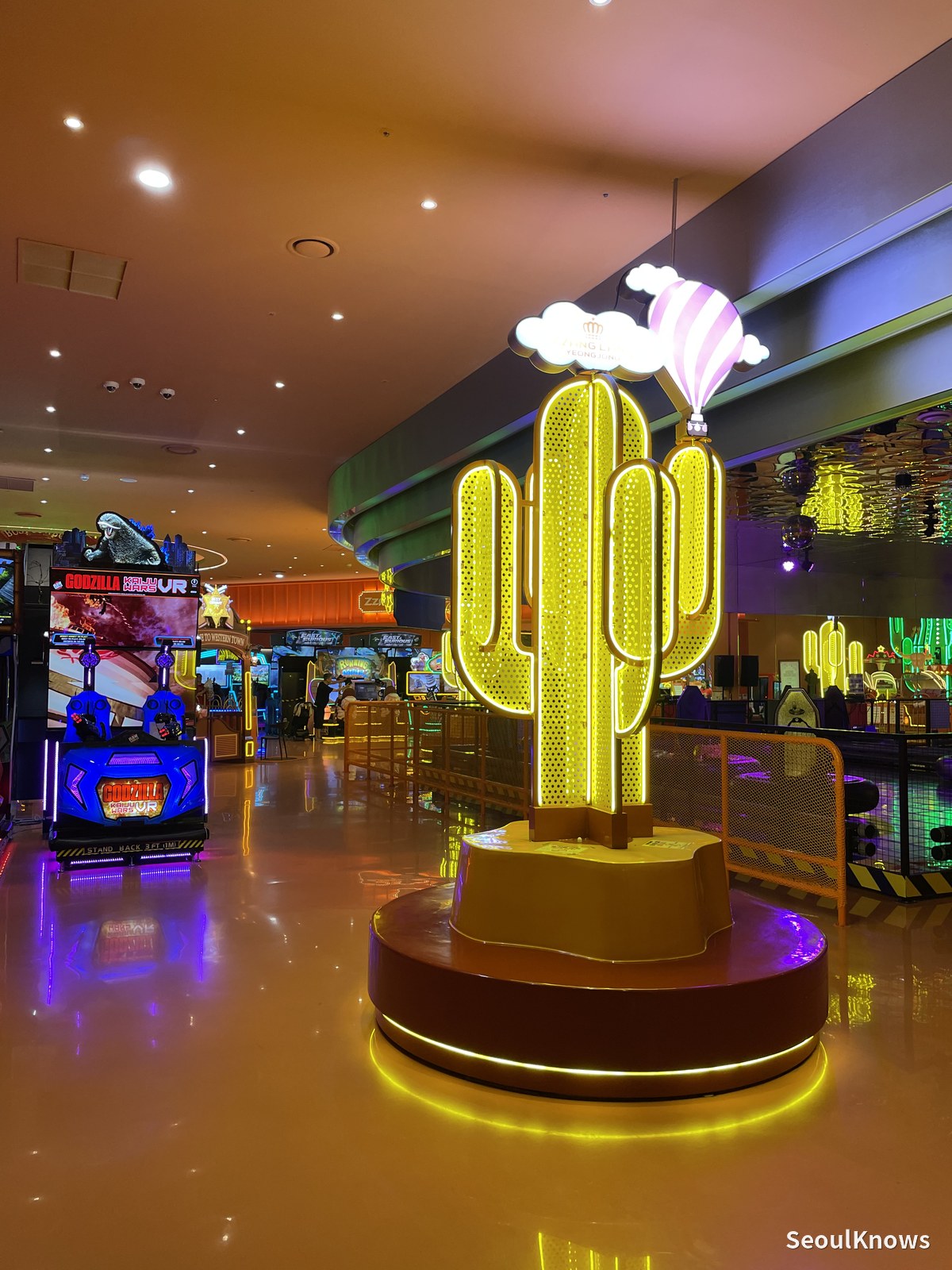Neon cactus sculpture inside the arcade at Inspire Resort